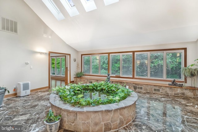 sunroom with visible vents and lofted ceiling with skylight