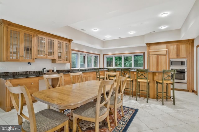 dining area featuring light tile patterned flooring