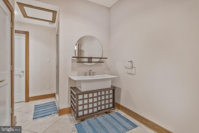 bathroom with tile patterned flooring and baseboards