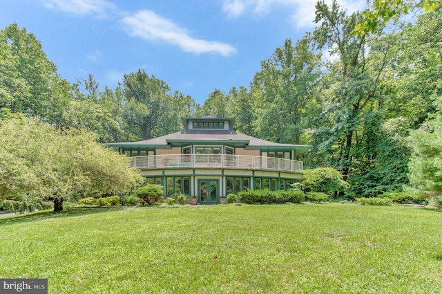 view of front of property featuring french doors and a front lawn