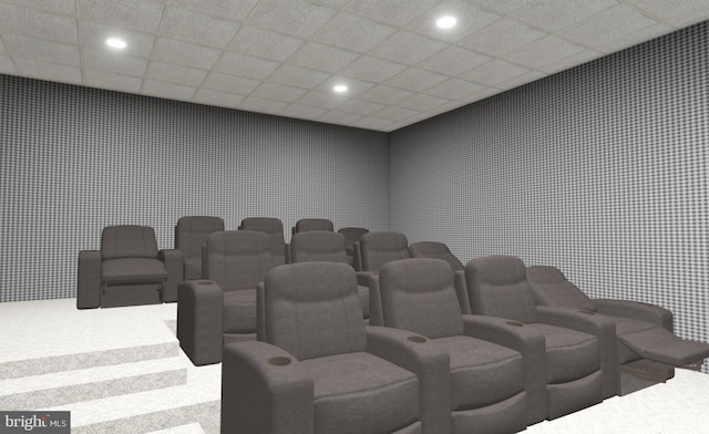 carpeted home theater with a paneled ceiling