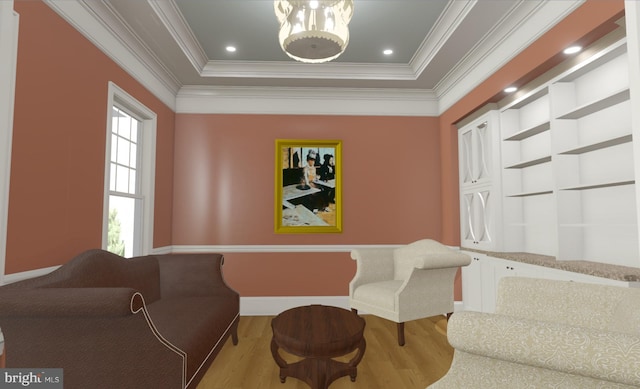 sitting room with a tray ceiling, light hardwood / wood-style flooring, and crown molding