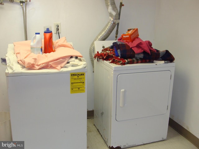 clothes washing area featuring washer and dryer and laundry area