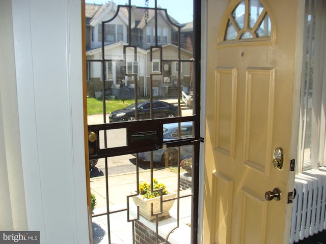 interior space with radiator heating unit and a residential view