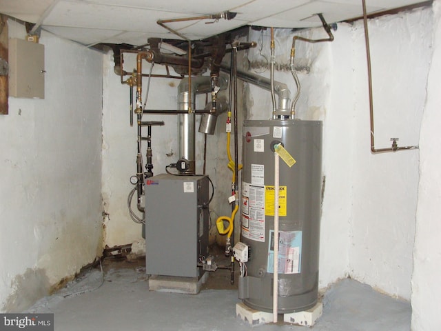 utility room with gas water heater and a heating unit