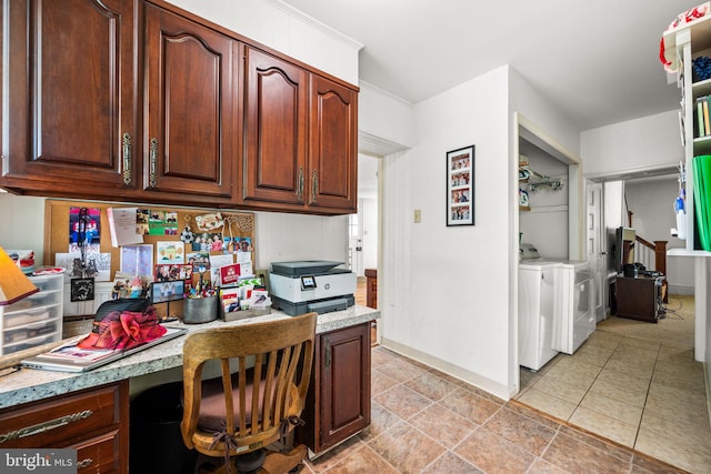 kitchen with washer and clothes dryer, light tile patterned flooring, and built in desk