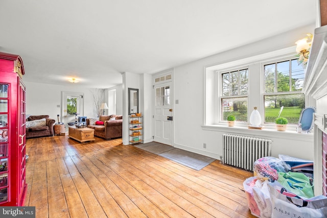 foyer entrance featuring radiator and light hardwood / wood-style flooring