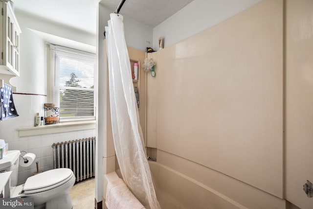 bathroom with toilet, tile walls, radiator, and shower / tub combo with curtain