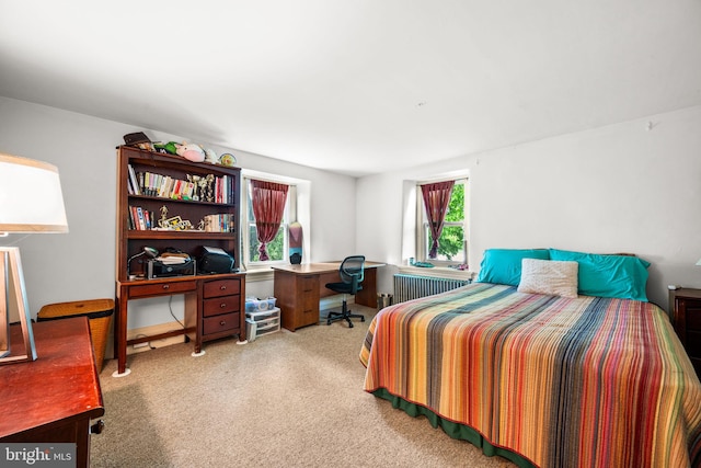 carpeted bedroom featuring radiator