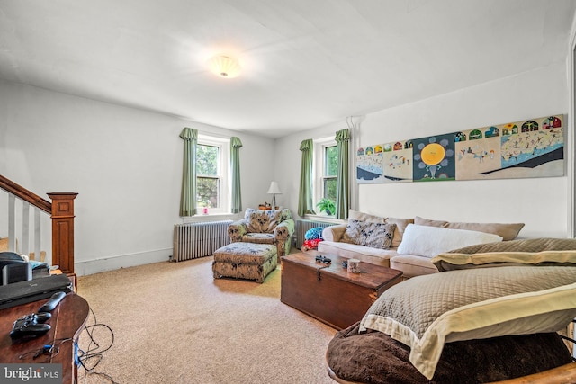 carpeted living room with radiator heating unit