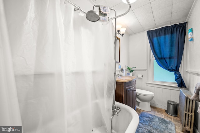 full bathroom featuring vanity, wood walls, toilet, and independent shower and bath