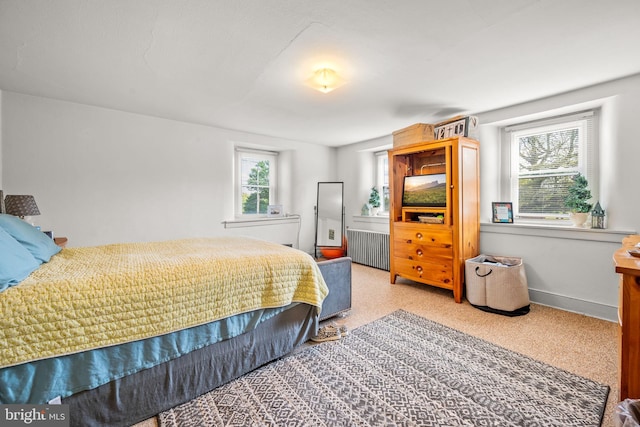 bedroom featuring carpet flooring and radiator