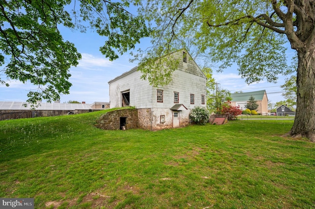 view of property exterior with a lawn