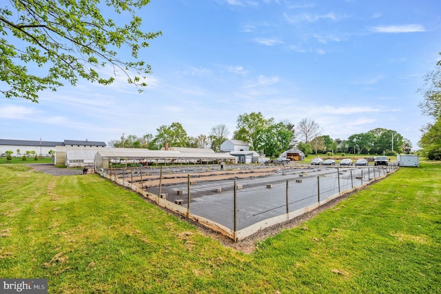 view of swimming pool featuring a lawn