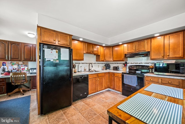 kitchen with black appliances, sink, decorative backsplash, built in desk, and light tile patterned floors