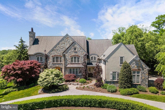 french country home featuring a front lawn