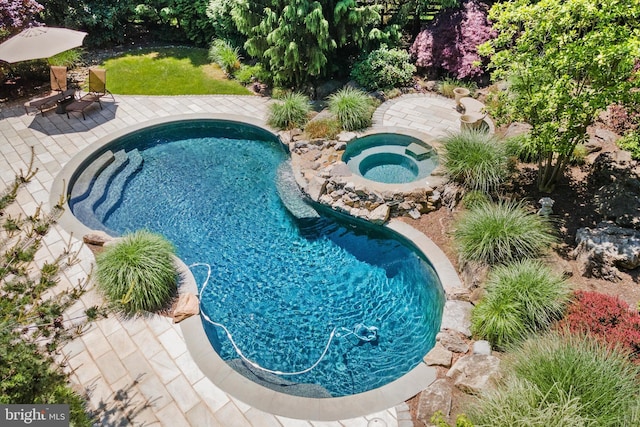 view of swimming pool featuring an in ground hot tub and a patio