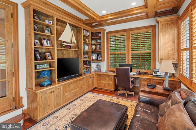 office area with ornamental molding, coffered ceiling, built in desk, light hardwood / wood-style flooring, and beamed ceiling