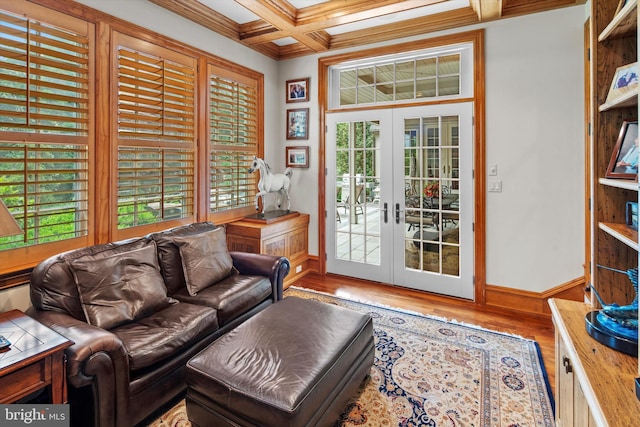 living room featuring french doors, plenty of natural light, and coffered ceiling