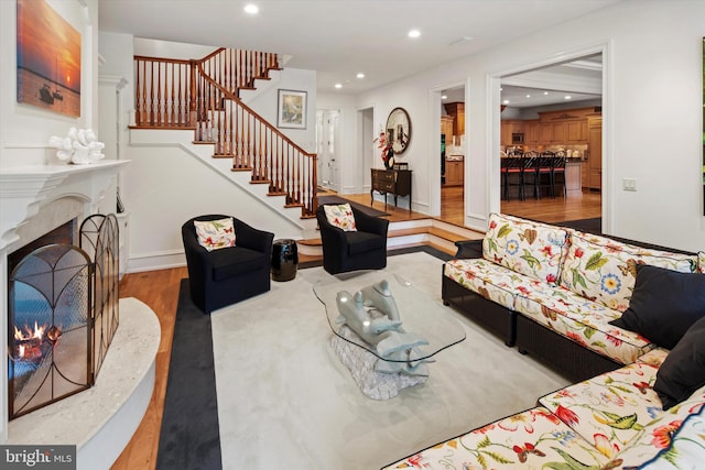 living room with light hardwood / wood-style flooring and a premium fireplace