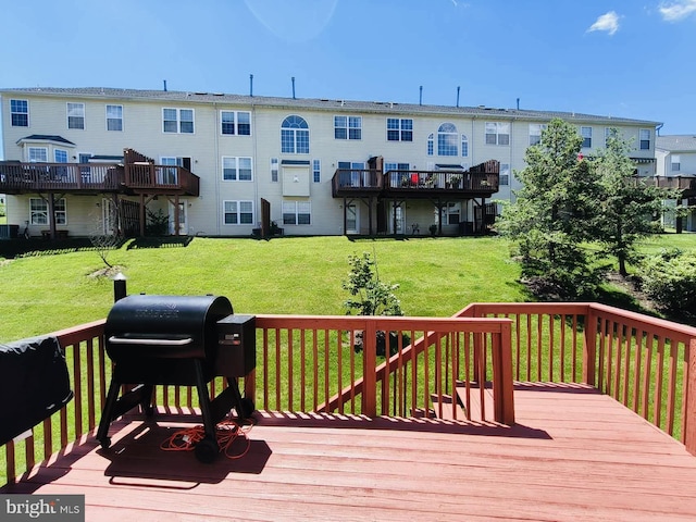 deck featuring a yard and a grill