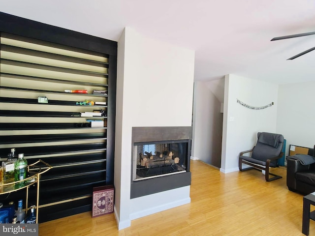 living room featuring ceiling fan and light hardwood / wood-style floors