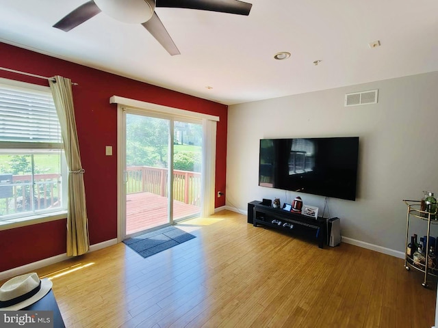 living room featuring ceiling fan and hardwood / wood-style floors