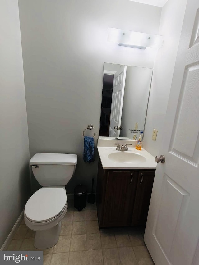 bathroom featuring tile patterned flooring, vanity, and toilet