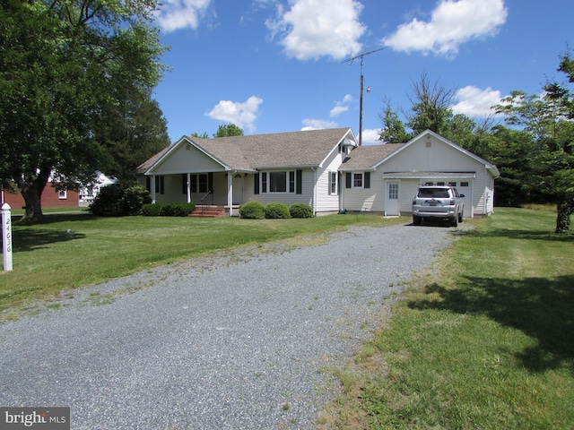 ranch-style house featuring a front yard, a porch, and a garage