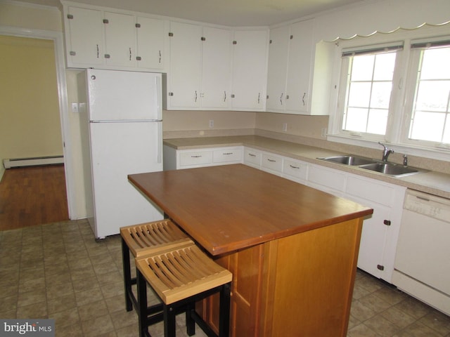 kitchen featuring a center island, white appliances, a baseboard heating unit, white cabinets, and sink