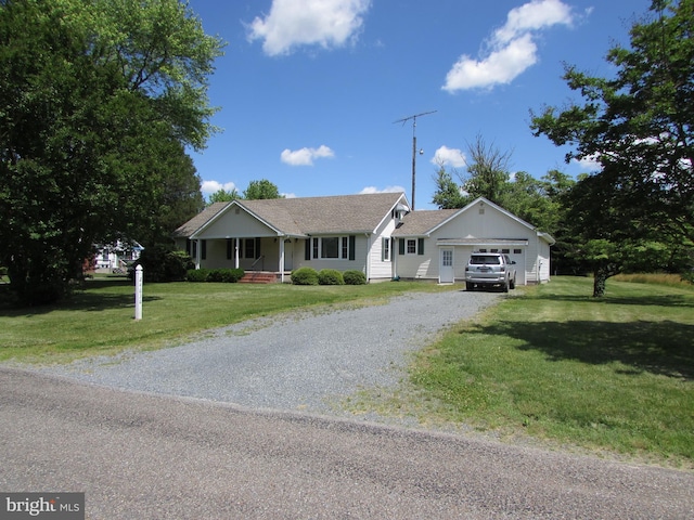 single story home with a front yard, a porch, and a garage