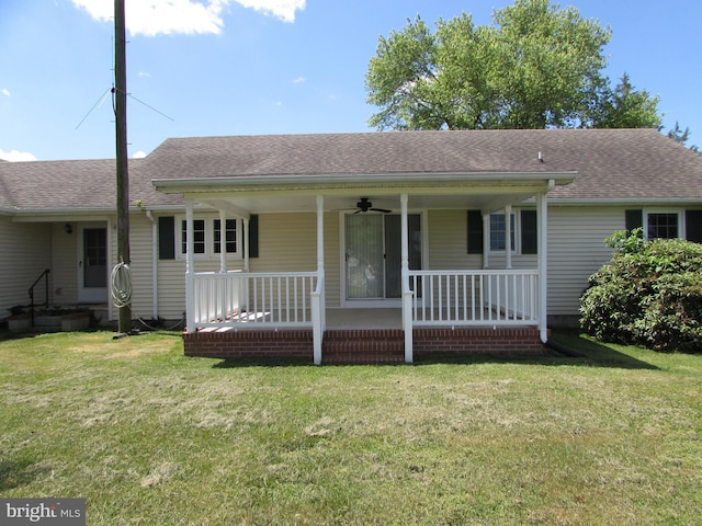 ranch-style house featuring covered porch and a front lawn