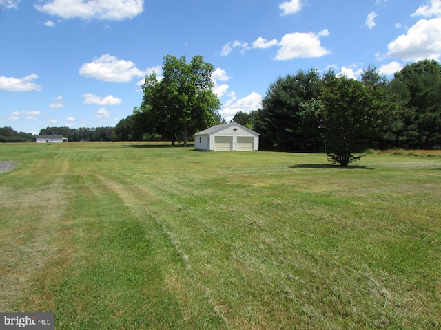 view of yard featuring an outbuilding and a garage