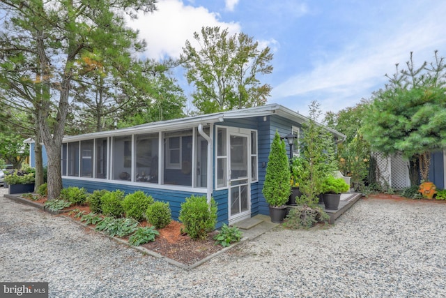 view of side of property featuring a sunroom