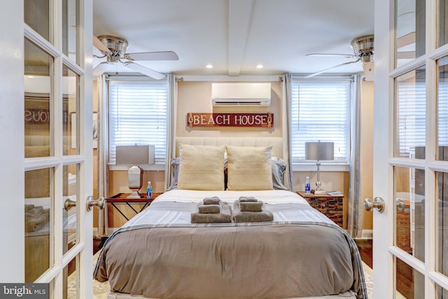 bedroom featuring a wall mounted air conditioner, multiple windows, and french doors