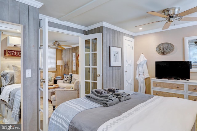 bedroom featuring an AC wall unit, ceiling fan, crown molding, and wood walls