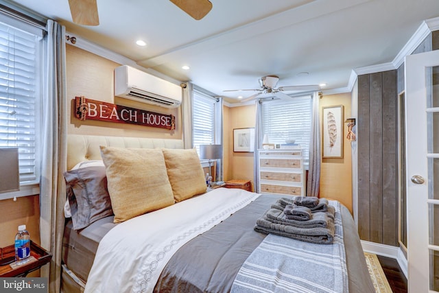 bedroom with hardwood / wood-style floors, a wall unit AC, ceiling fan, and crown molding