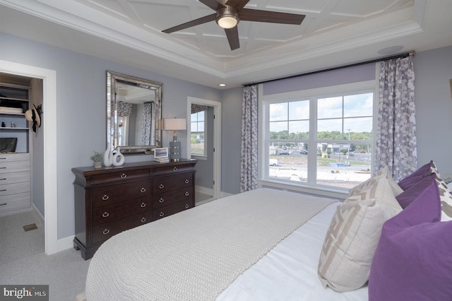 carpeted bedroom with ornamental molding, ceiling fan, and coffered ceiling