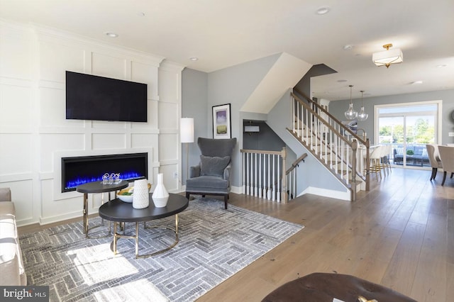 54 Becker Dr Unit 25, Chalfont, PA 18914 - living area featuring a chandelier, wood finished floors, baseboards, a glass covered fireplace, and recessed lighting