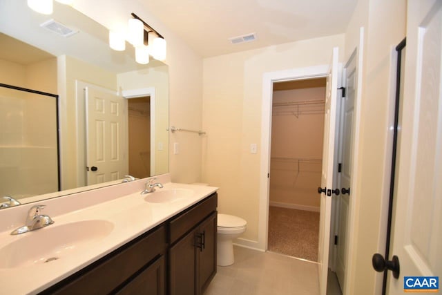 bathroom with vanity, toilet, and walk in shower