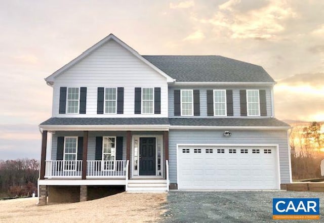 view of front of home featuring covered porch and a garage