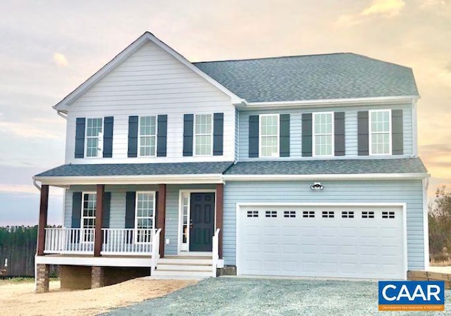 view of front of house featuring covered porch and a garage