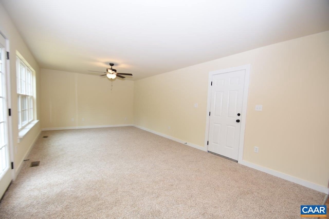 spare room featuring ceiling fan and light carpet