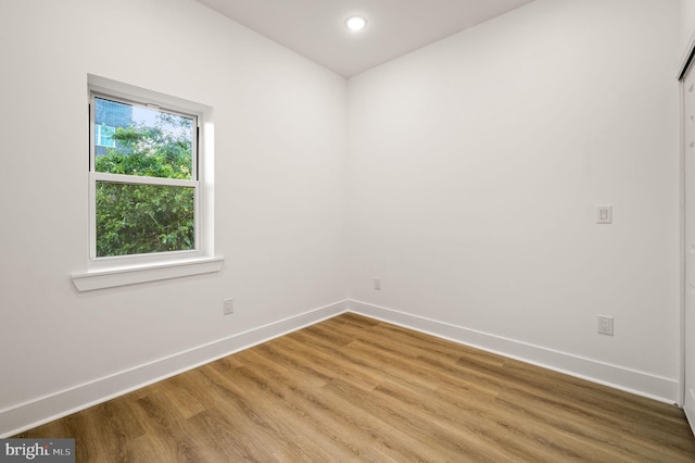 unfurnished room with wood-type flooring