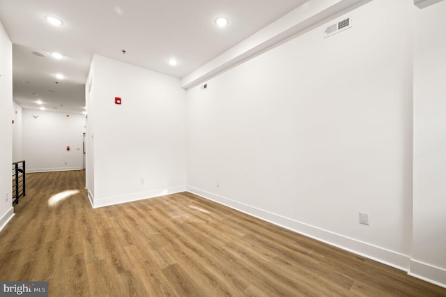 empty room with hardwood / wood-style flooring