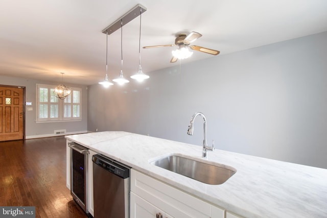 kitchen with dishwasher, white cabinets, pendant lighting, and sink