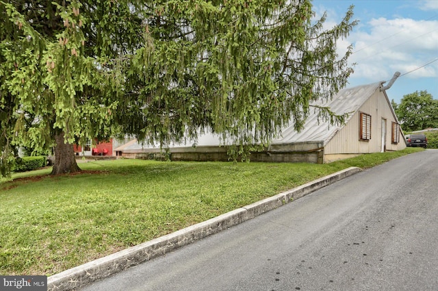 view of home's exterior with a lawn