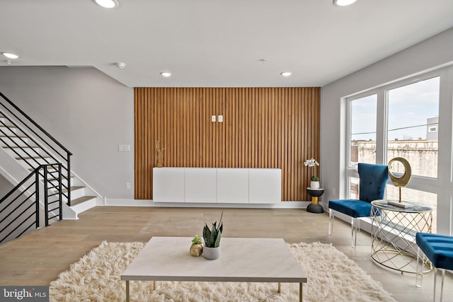 living room with wood walls and light hardwood / wood-style flooring