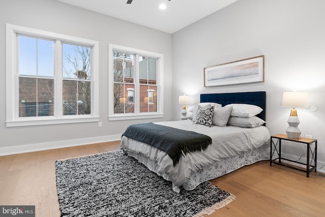 bedroom with ceiling fan and wood-type flooring