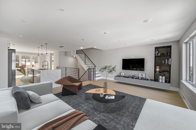 living room with sink and light hardwood / wood-style floors